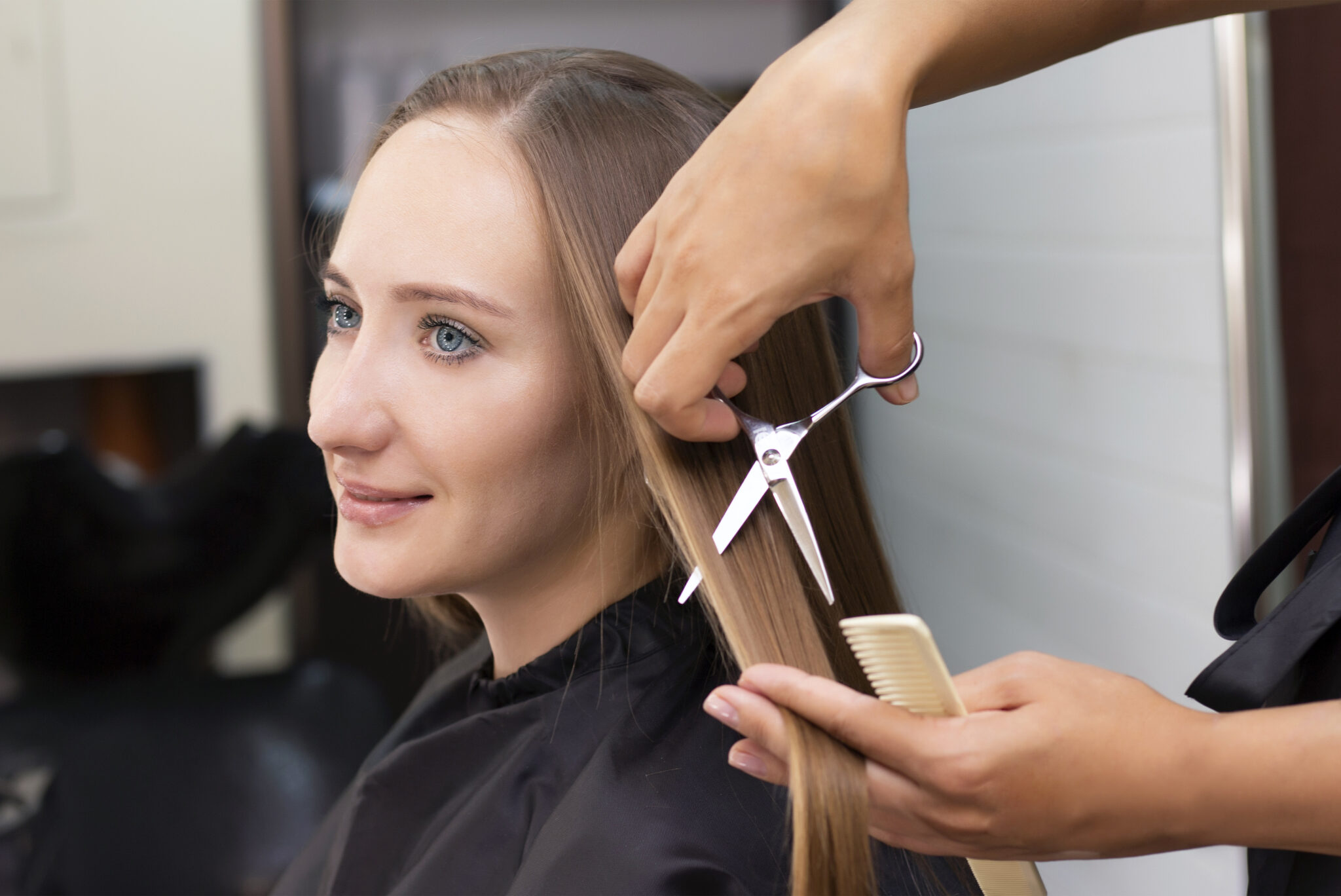 Womens hairdresser, beauty salon. Professional stylist cuts female hair in salon