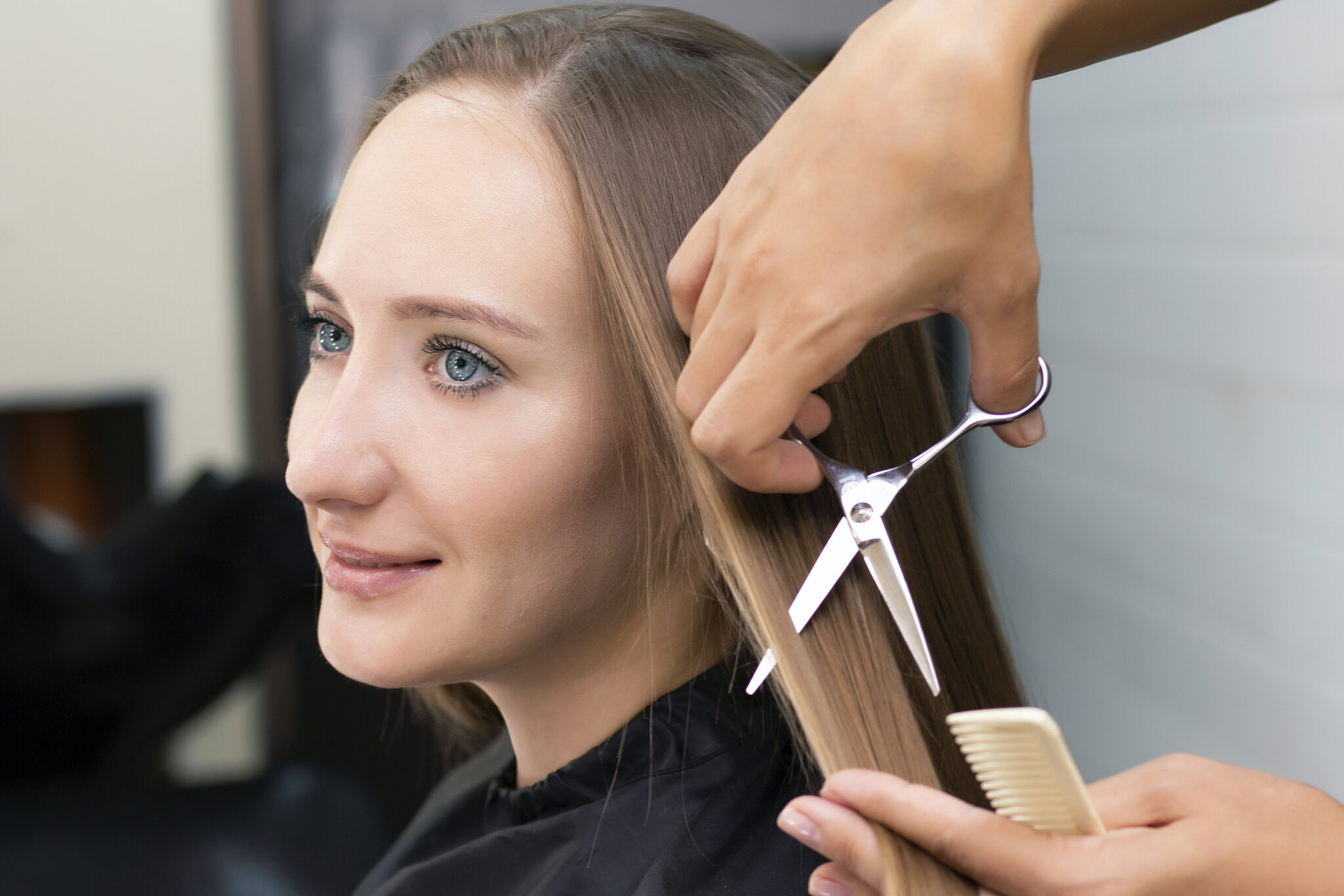 Womens hairdresser, beauty salon. Professional stylist cuts female hair in salon