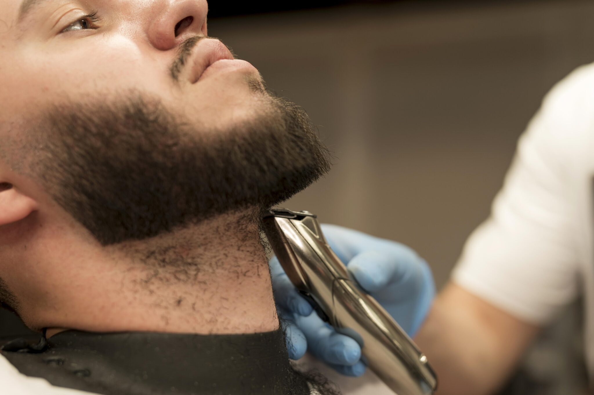 young-man-getting-his-beard-styled-barber
