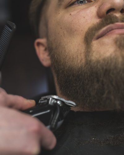 close-up-barber-trimming-beard-man