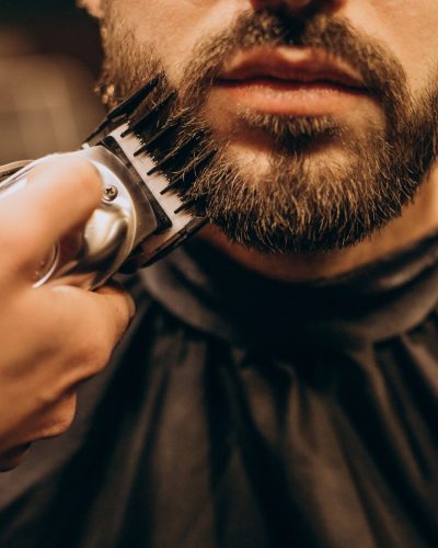 Handsome man at barbershop shaving beard