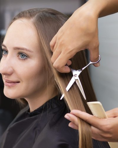Womens hairdresser, beauty salon. Professional stylist cuts female hair in salon