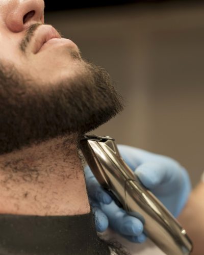 young-man-getting-his-beard-styled-barber